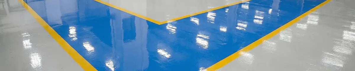 A factory floor professionally covered and marked with epoxy flooring in Aurora, CO