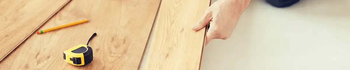 A professional installing wood flooring in Aurora, CO