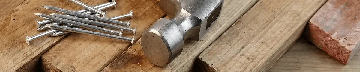 Hammer and nails on hardwood flooring boards in Aurora, CO