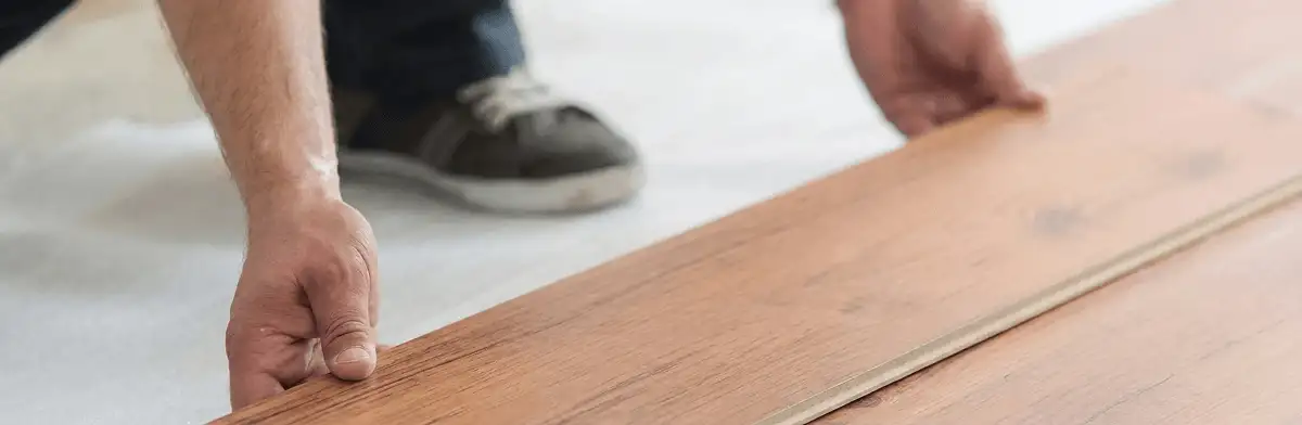 A professional installing laminate flooring in Aurora, CO