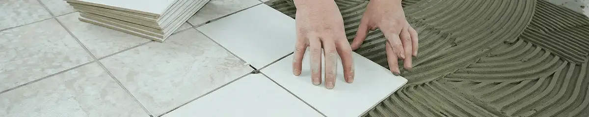 Professional installing white tile floors in Aurora, CO