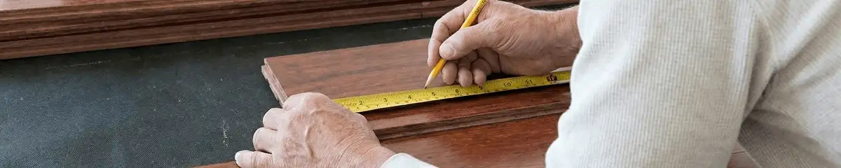 A professional installing wood flooring in Aurora, CO